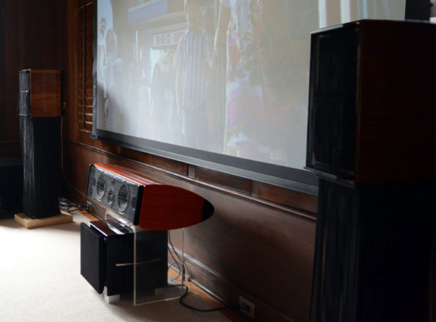 A center channel speaker with a REL subwoofer connected to create a REL 3D system in a home theater.